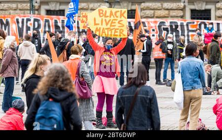 Amburgo, Germania. 23 maggio 2020. Un attivista dell'organizzazione di soccorso dei rifugiati Seebrücke sta dimostrando con un segnale che dice 'Black Lives Matter' al mercato del municipio per un programma nazionale di accoglienza per i rifugiati che attualmente si trovano nei campi al confine esterno dell'UE. Secondo la polizia di Amburgo, sabato a Rathausmarkt sono emminate 300 persone per l'evacuazione dei campi profughi in Grecia e l'accoglienza di almeno 1000 rifugiati nella città anseatica. Credit: Markus Scholz/dpa/Alamy Live News Foto Stock