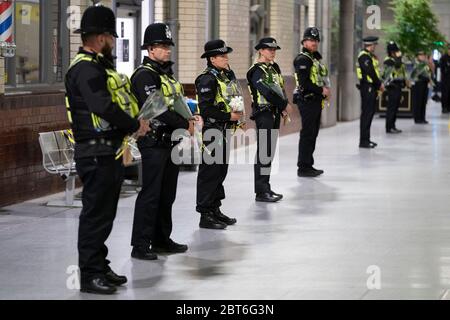 Manchester, Regno Unito. 22 maggio 2020. Gli ufficiali di polizia tengono in fila mazzi di fiori alla stazione ferroviaria di Manchester Victoria per celebrare il 3° anniversario della Manchester Arena Bomb, Manchester, Regno Unito. Credit: Jon Super/Alamy Live News. Foto Stock