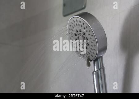 Acqua che fuoriesce dalla doccia delicatamente. L'acqua fuoriesce dalla doccia. Foto Stock
