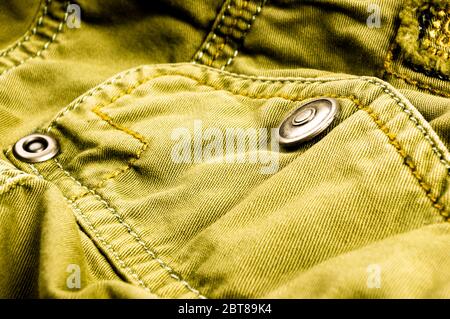 Articoli di abbigliamento stonewashed tessuto di cotone texture con cuciture, fibbie, bottoni e rivetti, macro Foto Stock