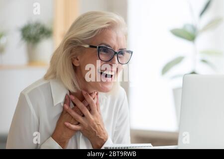 Sorpreso dipendente di mezza età ha letto una buona e-mail sul portatile Foto Stock