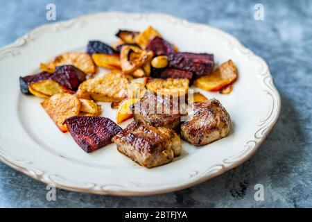 Bistecca di agnello con fette di barbabietola e patate al forno arrosto / Lokum turco Kuzu o delizia servita con piatto. Piatto di carne biologico. Foto Stock