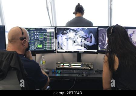 Gli astronauti della NASA Robert Behnken, sfondo, e Douglas Hurley, in primo piano, sono visti su un monitor che mostra all'interno della capsula Crew Dragon al complesso di lancio 39A durante una prova di vestiaria in preparazione al lancio di un razzo SpaceX Falcon 9 che trasporta la navicella spaziale Crew Dragon della società nella missione SpaceX Demo-2 della NASA, Il 23 maggio 2020, nella sala di cottura quattro del Launch Control Center presso il Kennedy Space Center della NASA in Florida. Credit: UPI/Alamy Live News Foto Stock