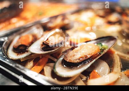 Cozze cucinate gourmet su un letto di verdure Foto Stock