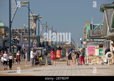 Great Yarmouth, Regno Unito. 25 maggio 2020. Con i parcheggi e le attrazioni sul mare rimasti chiusi a causa del coronavirus, Great Yarmouth non era molto occupato come il lunedì precedente delle feste della Banca di primavera, ma il lungomare del resort sembrava ancora attrarre un gran numero di persone che cercano una pausa di sole dalla chiusura. Solo alcune bancarelle di gelati e rinfreschi e venditori di cibo da asporto erano aperti, le misure sociali e altre misure sanitarie sono state ampiamente implementate. Foto Stock