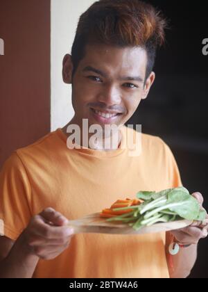 14 aprile 2019 - Kediri, Indonesia: Un giovane indonesiano che prepara il succo di verdure in casa Foto Stock