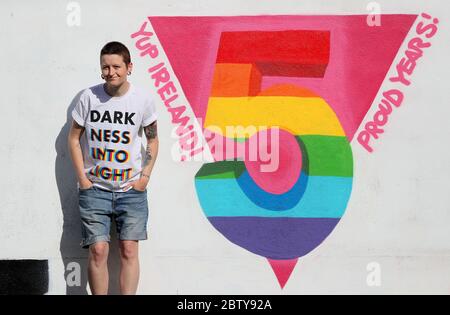 L'artista irlandese emmalene Blake con il suo murale che celebra il cinque anni di voto irlandese con referendum per legalizzare il matrimonio gay, svoltosi il 22 maggio 2015. Foto Stock