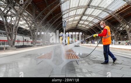 Lipsia, Germania. 27 maggio 2020. Un dipendente del DB pulisce e disinfetta un'area salotto della stazione centrale di Lipsia. Con più dispenser per mani disinfettanti, più frequenti pulizie e luce anti-virus, Deutsche Bahn vuole prepararsi per il crescente traffico di passeggeri nella crisi della corona nelle stazioni. Con le nuove macchine per la pulizia, le superfici potrebbero essere disinfettate più estesamente che in passato. Credit: Jan Woitas/dpa-Zentralbild/dpa/Alamy Live News Foto Stock