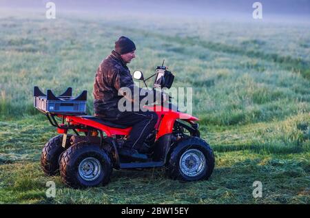 27 maggio 2020, Meclemburgo-Pomerania occidentale, Dummerstorf: Con un quad per tutti i terreni, un attivista del benessere degli animali è sulla strada prima dell'alba su un prato. I fawns sono trovati su un drone da attivisti del benessere animale con l'aiuto di una macchina fotografica di imaging termico e prima dell'alba sono circondati e protetti da una sorta di castello sulla spiaggia. Si stima che ogni anno nel solo nord-est, circa 26,000 falci vengono uccisi durante le operazioni di falciatura. Con i droni, i membri di Wild Animal Aid lo scorso anno hanno scoperto 146 fiabe su quasi 1,000 ettari e li ha protetti dalla falciatura prateria che wa Foto Stock