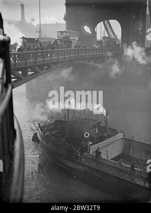 Riparazioni effettuate al letto del fiume sotto il ponte della torre . I lavori di riparazione sono in corso nel letto del Tamigi adiacente al Tower Bridge , dal porto di Londra . Il letto del fiume è stato scavato a questo punto da correnti e grandi quantità di zavorra sono state scaricate per riempire i fori in modo che non vi sia pericolo che le fondamenta del ponte siano messe in pericolo. Un drago impaccatura zavorra sotto il Tower Bridge per riempire i fori sotto il ponte . 8 marzo 1932 Foto Stock