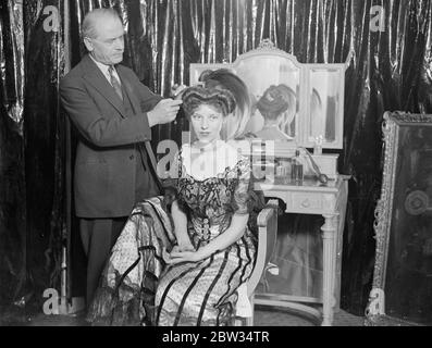 La modalità 1900 ritorna alla città . Parrucchieri in tutta Inghilterra stanno preparando modelli per una mostra di parrucchiere durante le età che si terrà a Londra . M Adolphe , un parrucchiere londinese , preparando il suo modello , la signorina Rosslyn Taylor , che rappresenterà una signora vittoriana dell' anno 1900 . 4 febbraio 1932 Foto Stock