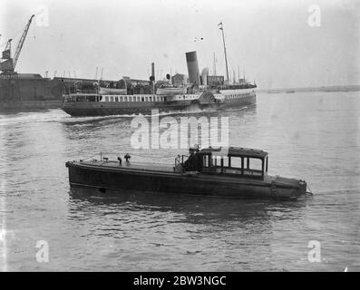 Guardia di polizia ' Queen Mary ' dagli avvistatori a Southampton . Migliaia di visitatori di Pasqua . La polizia di Southampton ha avuto un battito acqueo quando migliaia di turisti pasquali sono arrivati a ispezionare la ' Queen Mary '. Due poliziotti in uniforme erano in servizio su un motoscafo per impedire che barche da diporto non autorizzate entrassero nell' Ocean Dock , dove il gigantesco liner è ormeggiato . Spettacoli fotografici , polizia in uniforme che protegge l'Ocean Dock in un motoscafo mentre passa un piacevole vaporetto . 13 aprile 1936 Foto Stock