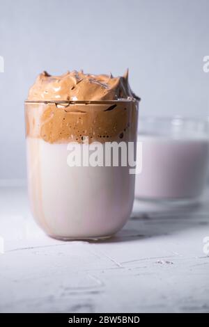 Caffè e latte di Dalgona sullo sfondo. Caffè ghiacciato coreano. Immagine verticale. Foto Stock