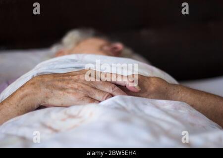Donna anziana che dorme a letto. Foto Stock