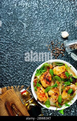 cosce di pollo sul piatto, cosce di pollo fritte con spinaci Foto Stock
