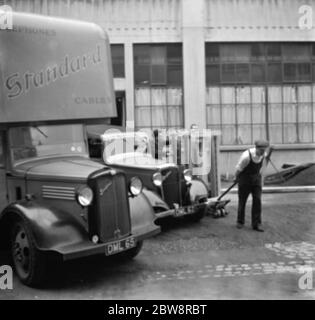 I camion Bedford appartenenti alla Standard Telephone and Cables Company Ltd , che vengono caricati fuori dalla loro fabbrica . 1936 . Foto Stock