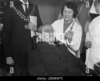 Lord Horder , il medico riconosciuto , apre una clinica sanitaria a Woolwich , Londra . Qui si siede nella sedia dentale . 15 gennaio 1939 Foto Stock