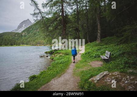 Svizzera, Bravuogn, Palpuognasee, giovane donna che cammina sul lago Palpuognasee nelle Alpi svizzere Foto Stock