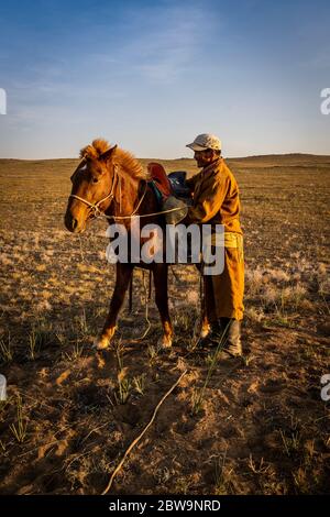 Pastore mongolo con abito tradizionale in steppa del deserto di Gobi con il suo discorso, Mongolia, Asia. Foto Stock