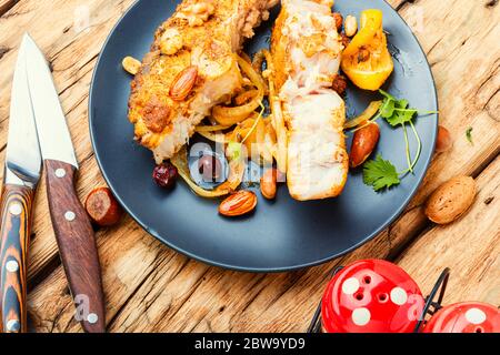 Pezzo di carpa d'argento arrosto con salsa di noci su tavola di legno Foto Stock