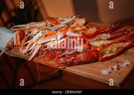 Langustins con lime e limone su una tavola boscosa Foto Stock