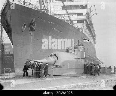 HMS Submarine No 3 la nuova corazzata sommergibile , che si trova accanto al gigante Cunarder ' Aquitania ' 30 marzo 1920 Foto Stock