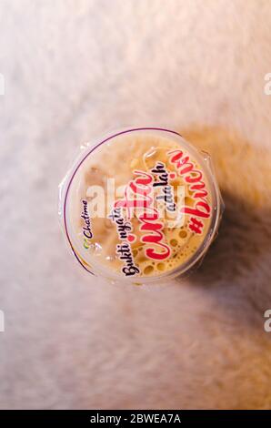 Un editoriale illustrativo del tè al latte fresco Brown Sugar della franchising Chatime con una vista dall'alto della frase scritta in bahasa indonesia Foto Stock