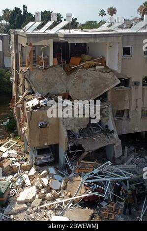 Un edificio residenziale mostra gravi danni dopo che è stato colpito direttamente da un razzo Hezbollah grad nel quartiere di Bat Galim nella città di Haifa durante la guerra di Israele - Hezbollah Foto Stock