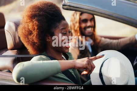 Happy People divertirsi in auto convertibile in vacanza estiva - giovane coppia injouryng vacanza su cabriolet auto all'aperto - Viaggi, stile di vita giovanile e. Foto Stock