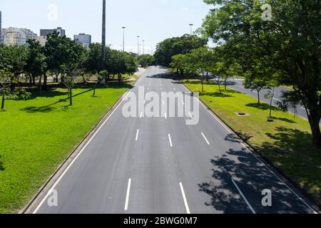 Bella vista sulla strada vuota dell'autostrada sulla zona verde con cielo blu, durante l'epidemia di covid-19 a Rio de Janeiro, Brasile Foto Stock