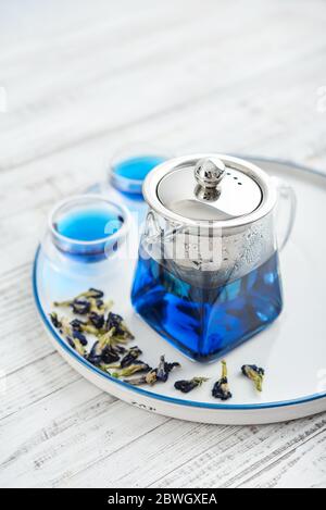 Due tazze di tè blu Anchan con teiera in vetro su guardaroba in legno Foto Stock