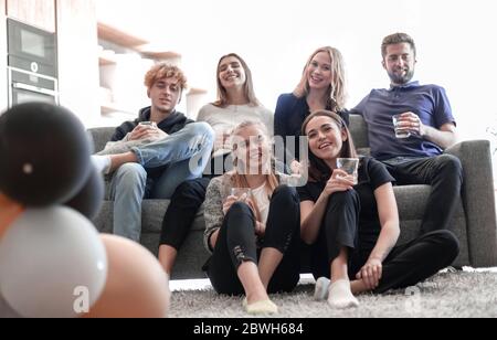 Amici allegri che si divertono e bevono a casa Foto Stock