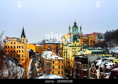 Kiev, Ucraina. Vista di Andrew è discesa in inverno durante il nuvoloso moody giorno. Neve oltre la montagna, famosa San Andrea Chiesa a Kiev, Ucraina Foto Stock