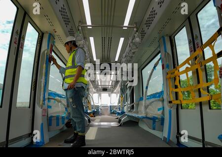 Chongqing. 3 Giugno 2020. Un ingegnere effettua test elettrici su un treno BYD SkyShuttle durante un'operazione di prova nel distretto di Bishan, Chongqing, nel sud-ovest della Cina, il 3 giugno 2020. Il primo progetto di transito ferroviario SkyShuttle di Chongqing è stato recentemente presentato, con treni elettrici a ruote gommate che corrono su una linea ferroviaria di 15.4 km con 15 stazioni. Il progetto fornirà ai passeggeri servizi di viaggio tranquilli e sicuri in base alla sua prevista attività pubblica nel settembre 2020. Credit: Liu Chan/Xinhua/Alamy Live News Foto Stock