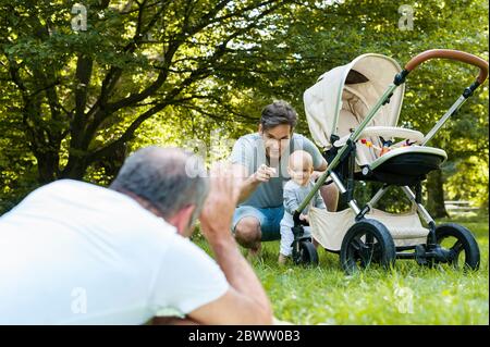 Uomo anziano che passa il tempo con il figlio adulto e la nipote in un parco Foto Stock