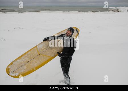 Surfista con tavola da surf nella neve in Ontario, Canada Foto Stock