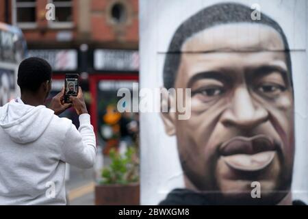 Manchester, Regno Unito. 3 Giugno 2020. Un membro del pubblico scatta una fotografia di un murale di George Floyd, l'uomo nero di 46 anni, morto a Minneapolis, Minnesota, il 25 maggio dopo che Derek Chauvin, un ufficiale bianco del Dipartimento di polizia di Minneapolis, ha premuto il ginocchio al collo di Floyd, Manchester, Regno Unito. Credit: Jon Super/Alamy Live News. Foto Stock