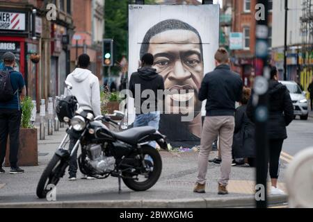 Manchester, Regno Unito. 3 Giugno 2020. I membri del pubblico sono visti da un murale di George Floyd, l'uomo nero di 46 anni, morto a Minneapolis, Minnesota, il 25 maggio dopo che Derek Chauvin, un ufficiale bianco del Dipartimento di polizia di Minneapolis, ha premuto il ginocchio al collo di Floyd, Manchester, Regno Unito. Credit: Jon Super/Alamy Live News. Foto Stock