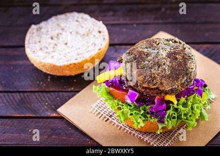 hamburger vegetariano, arrosto e pronto per il consumo. Concetto di vita sana e vegetariana. Spuntino senza carne a base di soia e ceci con verdure fresche Foto Stock