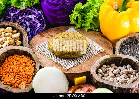 hamburger vegano, arrosto e pronto per il consumo. Concetto di vita sana e vegetariana. Spuntino senza carne a base di soia e ceci con verdure fresche. Foto Stock