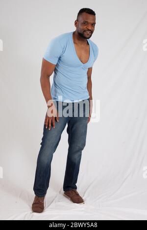 Uomo nero felice in camicia blu sorridente Foto Stock