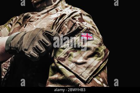 Foto di un soldato britannico in tunica mimetizzatrice multicam con tasca su sfondo nero. Foto Stock