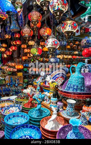 Vari souvenir colorati, tra cui ciotole in ceramica turca, ornamenti e lanterne in vendita presso una bancarella all'interno del Grand Bazaar di Istanbul in Turchia. Foto Stock