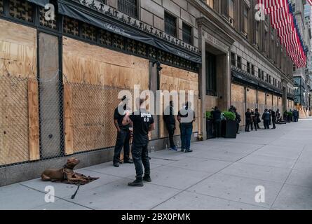 New York, Stati Uniti. 03 giugno 2020. Vista del grande magazzino Saks 5th Avenue con finestre a bordo con legno compensato, filo spolverato in cima e dozzina di guardie di sicurezza con cani durante la pandemia COVID-19 e protesta contro l'uccisione di George Floyd a Manhattan. (Foto di Lev Radin/Pacific Press) Credit: Pacific Press Agency/Alamy Live News Foto Stock