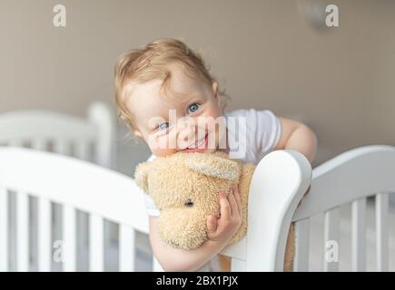 Ragazza allegra che gioca con un orsacchiotto di buon umore. Foto Stock