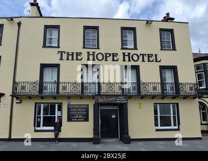 Un uomo siede fuori dall'Hope Hotel chiuso a Southend, Essex, Come ha detto il segretario culturale Oliver Dowden ai Comuni che in ottobre potrebbe essere creata una nuova festa bancaria per aiutare l'industria turistica britannica e ha annunciato che il governo "investirà estesamente" in una grande campagna per promuovere le vacanze alle città costiere britanniche dopo le misure di blocco ancora più rilassato. Foto Stock