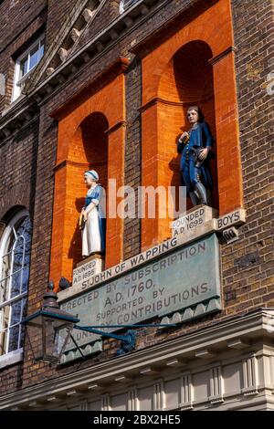 Statue Bluecoat alla St. John's Old School, Wapping, Londra, Inghilterra, Regno Unito Foto Stock