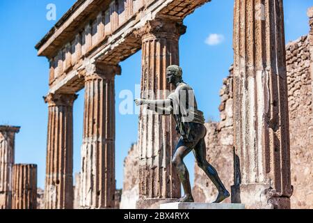 Pompei, Napoli, Italia. Rovine dell'antico tempio di Apollo con statua in bronzo di Apollo. Foto Stock