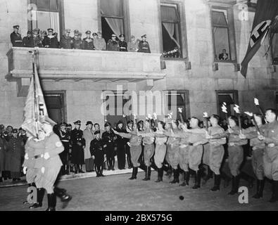 Sfilata di fiaccolate dell'Alte Kaempfer ('Old Fighters') di fronte ad Adolf Hitler (sul balcone della Cancelleria del Reich) alla vigilia del suo compleanno a Wilhelmsplatz a Berlino. Proprio accanto a Hitler si trova Rudolf Hess. Foto Stock