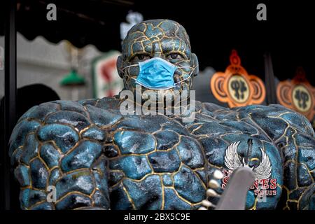 Maschera COVID-19 ; Statua della 'cosa', Marvel Comics fantastico quattro supereroe indossando una maschera protettiva del virus Corona Foto Stock